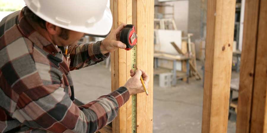 Electrician measuring for wiring House shopping tips for a fixer upper