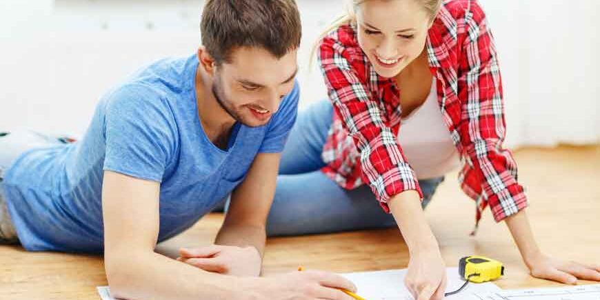 Refinance to Renovate a man and a woman on floor looking at blueprints