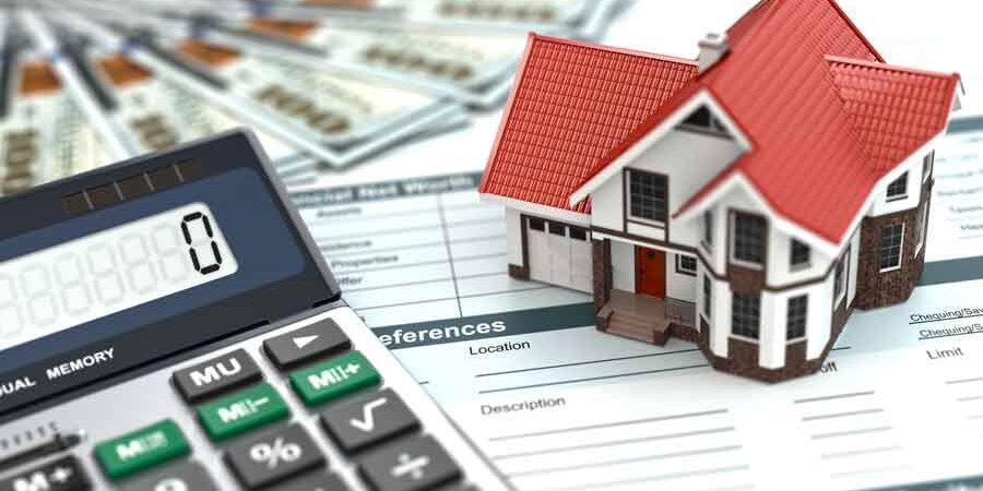 Mortgage Interest Rates mortgage calculator next to a model hows and money on a financial sheet