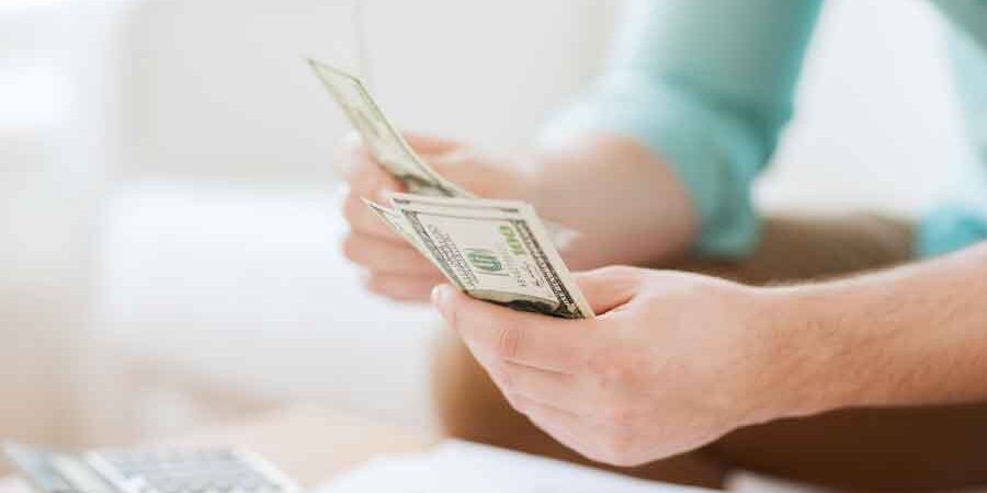 man counting money to save for down payment