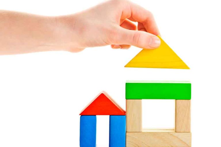 manufactured home mortgage hand assembling a model toy house