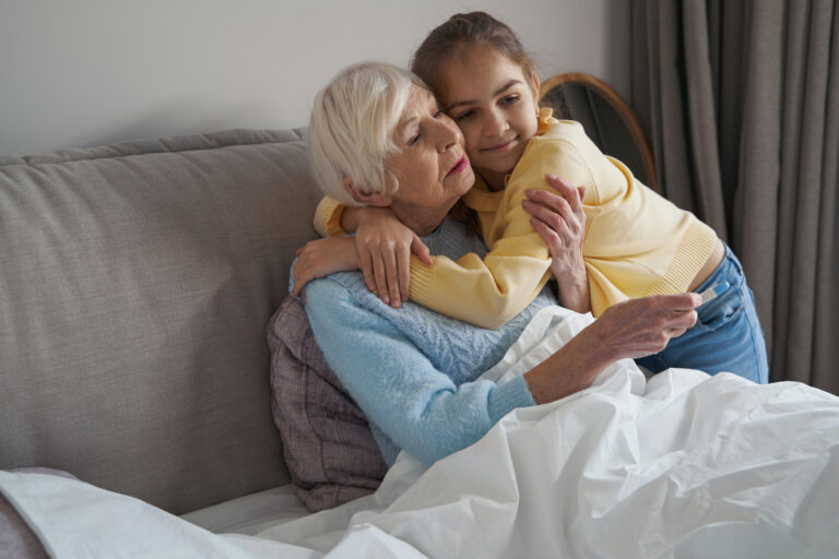 Grandma not feeling well and receiving loving embrace from kid