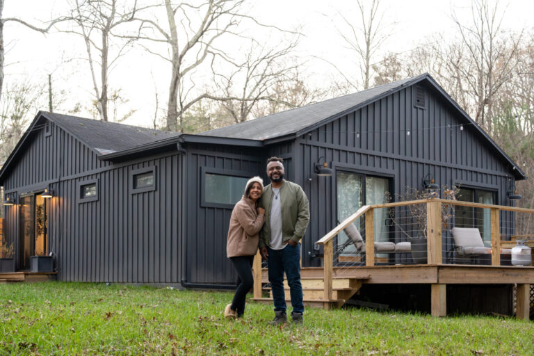 10-asheville-homebuyer-mortgage-mistakes-to-avoid First-time homebuyers in Asheville, NC standing outside their new home