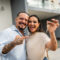 Man and woman holding keys after buying home in Asheville, NC