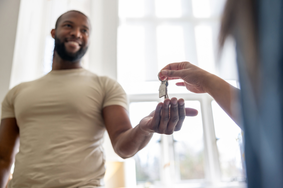 Man getting keys from real estate agent