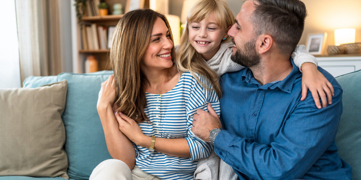 Family sitting on couch at home