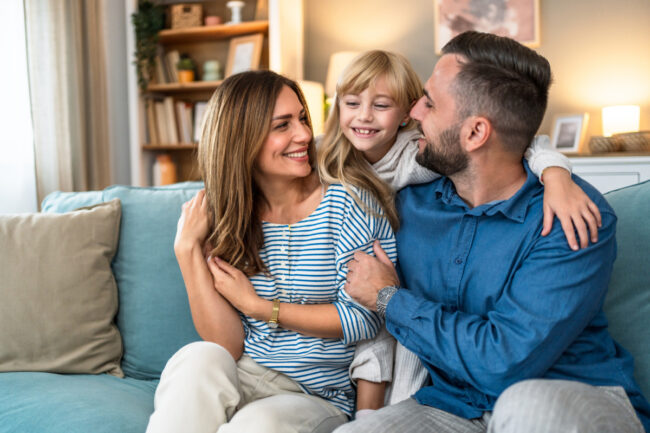 Family sitting on couch at home