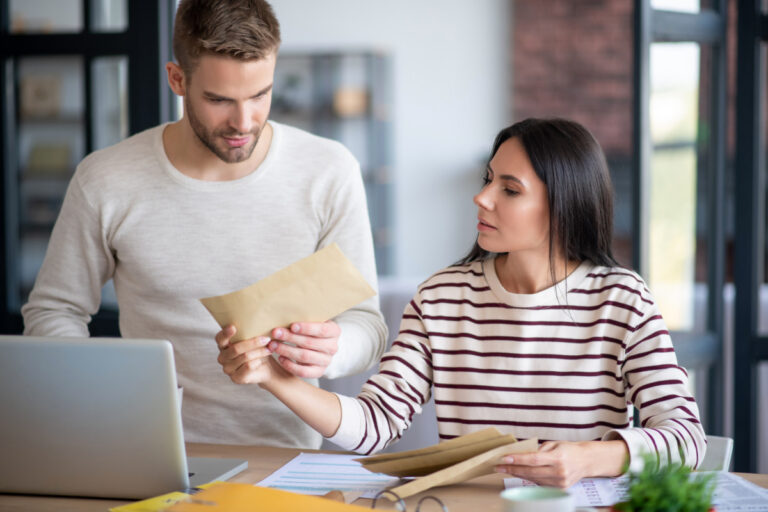 buncombe-county-property-assessment-went-up-mortgage-rate Young couple reading new assessed value for property